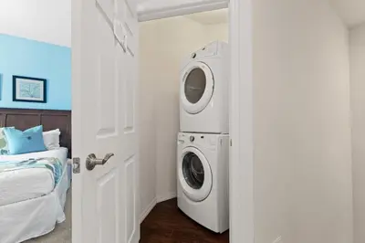 a washer and dryer in a room with a bed at Disney Getaway Private Pool Themed Bedrooms. Book Now WLV19 in Kissimmee