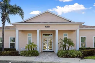 a house with palm trees in front of it at Disney Getaway Private Pool Themed Bedrooms. Book Now WLV19 in Kissimmee