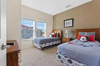 a bedroom with two beds and a window at Disney Getaway Private Pool Themed Bedrooms. Book Now WLV19 in Kissimmee