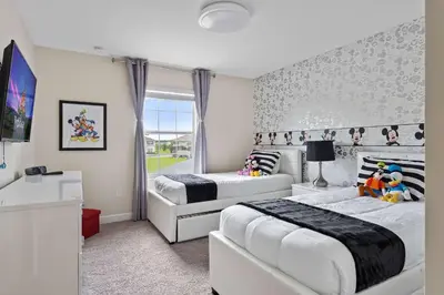 a bedroom with two beds and a window at Disney Getaway Private Pool Themed Bedrooms. Book Now SLR506 in Kissimmee
