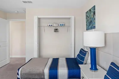 a bedroom with a bed and a door with a lamp at Disney Getaway Townhouse with Private Pool. Book Now SLR504 in Kissimmee