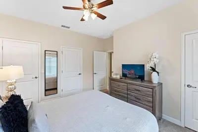 a bedroom with a bed and a ceiling fan at Disney Getaway Private Pool Themed Bedrooms. Book Now SLR505 in Kissimmee