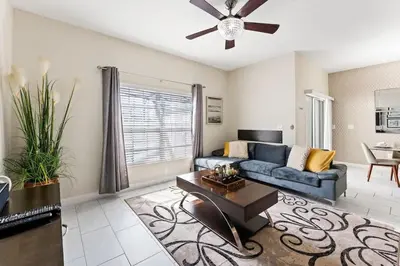 a living room with a couch and a ceiling fan at Disney Getaway Private Pool Themed Bedrooms. Book Now SLR505 in Kissimmee