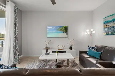 a living room with a couch and a table at Disney Getaway Luxury Condo with Private Balcony. Book Now SLR507 in Kissimmee
