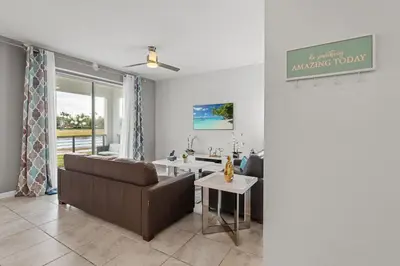 a living room with a couch and a table at Disney Getaway Luxury Condo with Private Balcony. Book Now SLR507 in Kissimmee