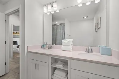 a bathroom with two sinks and a large mirror at Disney Getaway Luxury Condo with Private Balcony. Book Now SLR507 in Kissimmee