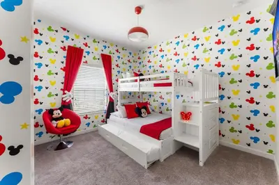 a childs bedroom with a white bed and colorful wallpaper at Disney Getaway Private Pool Themed Bedrooms. Book Now SLR499 in Kissimmee