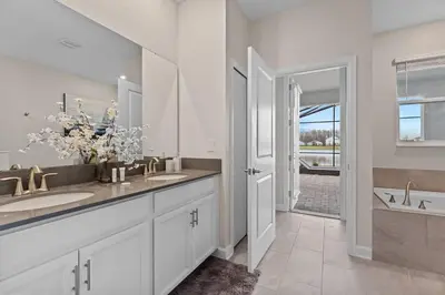a white bathroom with two sinks and a large mirror at Disney Private Pool Game Room Themed Bedrooms. Book Now SLR493 in Kissimmee