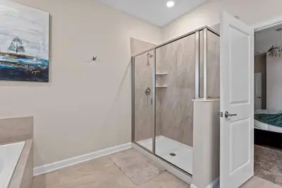 a bathroom with a shower with a glass door at Disney Private Pool Game Room Themed Bedrooms. Book Now SLR493 in Kissimmee