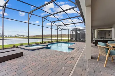 an indoor swimming pool in a building with a view of the water at Disney Private Pool Game Room Themed Bedrooms. Book Now SLR493 in Kissimmee