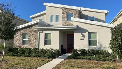 a white house with a red door at Disney Private Pool Game Room Themed Bedrooms. Book Now SLR493 in Kissimmee