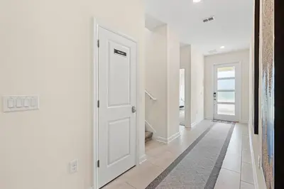 a hallway with white doors and a tile floor at Disney Private Pool Hot Tub Themed Bedrooms. Book Now SLR494 in Kissimmee