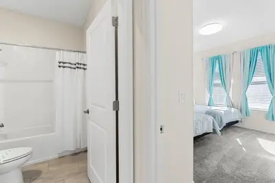a bathroom with a toilet and a bed in a room at Disney Private Pool Hot Tub Themed Bedrooms. Book Now SLR494 in Kissimmee
