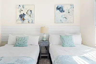 two beds sitting next to each other in a bedroom at Disney Private Pool Hot Tub Themed Bedrooms. Book Now SLR494 in Kissimmee