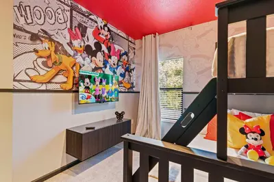 a childs bedroom with a disney mural on the wall at Disney Getaway Private Pool Themed Bedrooms. Book Now PG54 in Orlando