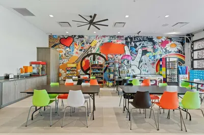a restaurant with tables and chairs and a wall with graffiti at Disney Getaway Private Pool Themed Bedrooms. Book Now PG54 in Orlando