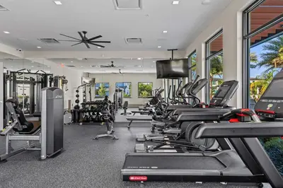 a gym with a bunch of treadmills and machines at Disney Getaway Private Pool Themed Bedrooms. Book Now PG54 in Orlando