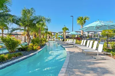 a swimming pool with chairs and umbrellas at a resort at Disney Getaway Private Pool Themed Bedrooms. Book Now PG54 in Orlando