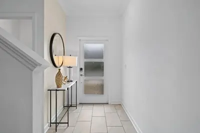 a hallway with a mirror and a table with a vase at Disney Getaway Private Pool Themed Bedrooms. Book Now SLR370 in Kissimmee