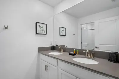 a bathroom with two sinks and a large mirror at Disney Getaway Private Pool Themed Bedrooms. Book Now SLR370 in Kissimmee