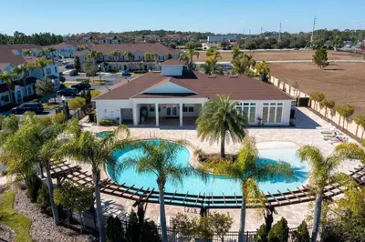 an aerial view of a resort with a pool and palm trees at Disney Getaway Private Pool Themed Bedrooms. Book Now WLV5 in Kissimmee