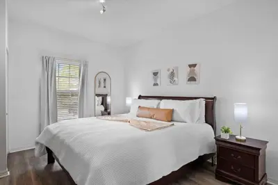 a white bedroom with a large bed and a window at Disney Getaway Private Pool Themed Bedrooms. Book Now WLV5 in Kissimmee