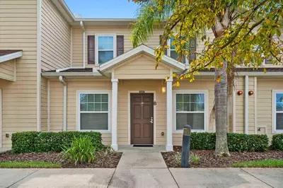 a house with a brown door and a tree at Disney Getaway Private Pool Themed Bedrooms. Book Now WLV5 in Kissimmee