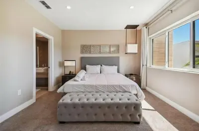 a bedroom with a large bed and a large window at Disney Getaway Townhouse with Private Pool. Book Now MVV18 in Orlando