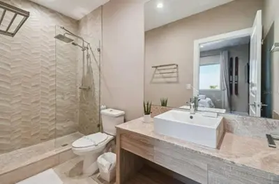 a bathroom with a sink and a toilet and a shower at Disney Getaway Townhouse with Private Pool. Book Now MVV18 in Orlando