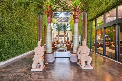 a lobby with two statues in a building with palm trees at Disney Getaway Townhouse with Private Pool. Book Now MVV18 in Orlando
