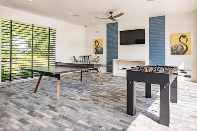 two ping pong tables in a room at Pinnacle Apartments W Amenties by Heavenly Homes in Orlando