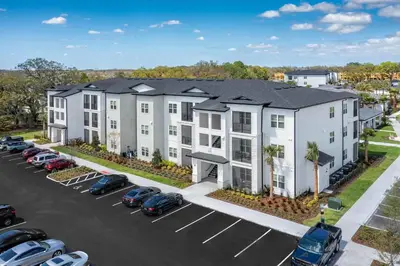 an aerial view of a building with cars parked in a parking lot at Pinnacle Apartments W Amenties by Heavenly Homes in Orlando