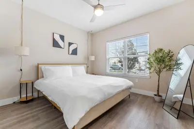 a bedroom with a large bed and a window at Pinnacle Apartments W Amenties by Heavenly Homes in Orlando