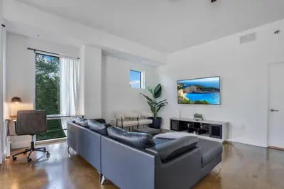 a living room with a couch and a table at 3 bedroom Corner Suite in Orlando