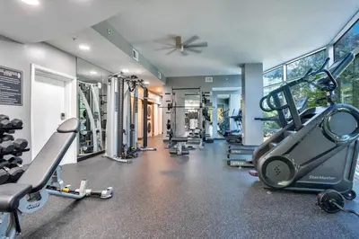 a gym with several treadmills and machines at 3 bedroom Corner Suite in Orlando