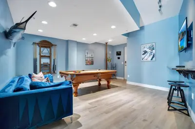a living room with a pool table and blue walls at 2 Bdrm Penthouse with Billiards in Orlando