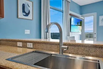 a kitchen with a stainless steel sink and a window at 2 Bdrm Penthouse with Billiards in Orlando