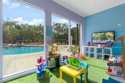 a childs play room with a pool and a tv at Cozy Family House near Disney 8108 in Kissimmee