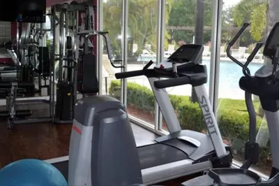 a gym with a treadmill and a large window at Cozy Family House near Disney 8108 in Kissimmee