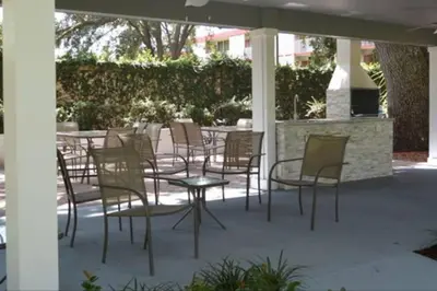 a group of chairs and tables on a patio at Cozy Family House near Disney 8108 in Kissimmee