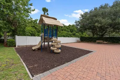a playground with a slide and an umbrella at Cozy Family House near Disney 8108 in Kissimmee