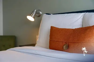 a bedroom with a bed with a pillow and a lamp at Volcano View 2 Bed 2 Bath Condo with Balcony in Orlando