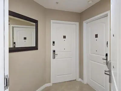a bathroom with two white doors and a mirror at 2BR 2BA Grand Duo Suite Sleeps 8 Near Universal and I Drive in Orlando