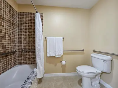 a bathroom with a toilet and a tub and a sink at 2BR 2BA Grand Duo Suite Sleeps 8 Near Universal and I Drive in Orlando