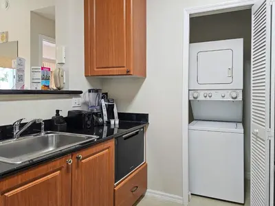 a small kitchen with a sink and a dishwasher at 2BR 2BA Grand Duo Suite Sleeps 8 Near Universal and I Drive in Orlando