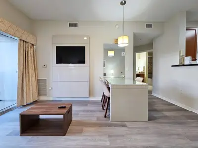 a living room with a kitchen and a table at 2BR 2BA Grand Duo Suite Sleeps 8 Near Universal and I Drive in Orlando
