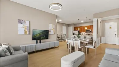 a living room with a dining table and a kitchen at Near Universal's Epic Universe Suite -3BR in Orlando