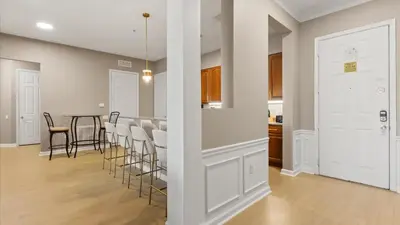 a kitchen and dining room with a table and chairs at Near Universal's Epic Universe Suite -3BR in Orlando