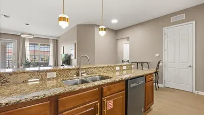 a kitchen with a sink and a large mirror at Near Universal's Epic Universe Suite -3BR in Orlando
