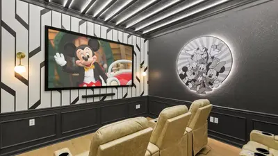 a living room with a cartoon monkey on the tv at Near Universal's Epic Universe Suite -3BR in Orlando